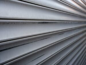 Metal lines form a patterned, angled background.